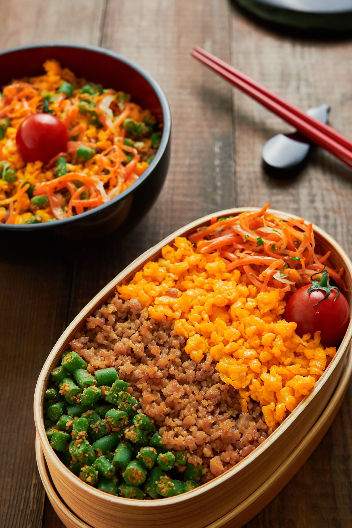 With a rainbow of chicken, eggs, and veggies over rice, this easy delicious Soboro Bento comes together for under $3 per serving from ingedients you probably have in your kitchen.