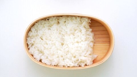 Rice packed into a wooden bento box.