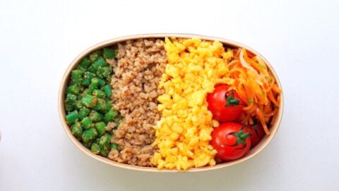 Chicken Soboro, Egg Soboro, and Green Bean Goma-ae packed into a wooden bento box.