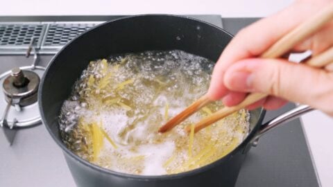 Boiling spaghetti in salted water for making Napolitan.