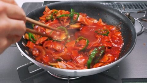 Spaghetti Napolitan sauce simmering in a frying pan.