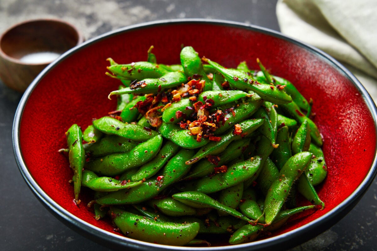 A fragrant trio of garlic, black pepper, and chili peppers turns this ordinary bowl of edamame into something extraordinary.