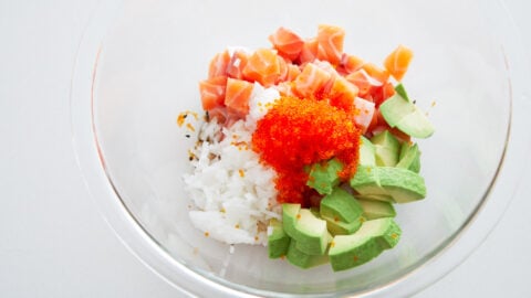 Ingredients for spicy salmon poke. Raw salmon, sweet onions, avocado, and tobiko.