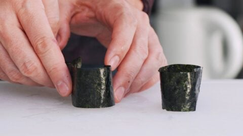 Wrapping sushi rice with nori for Gunkan roll.