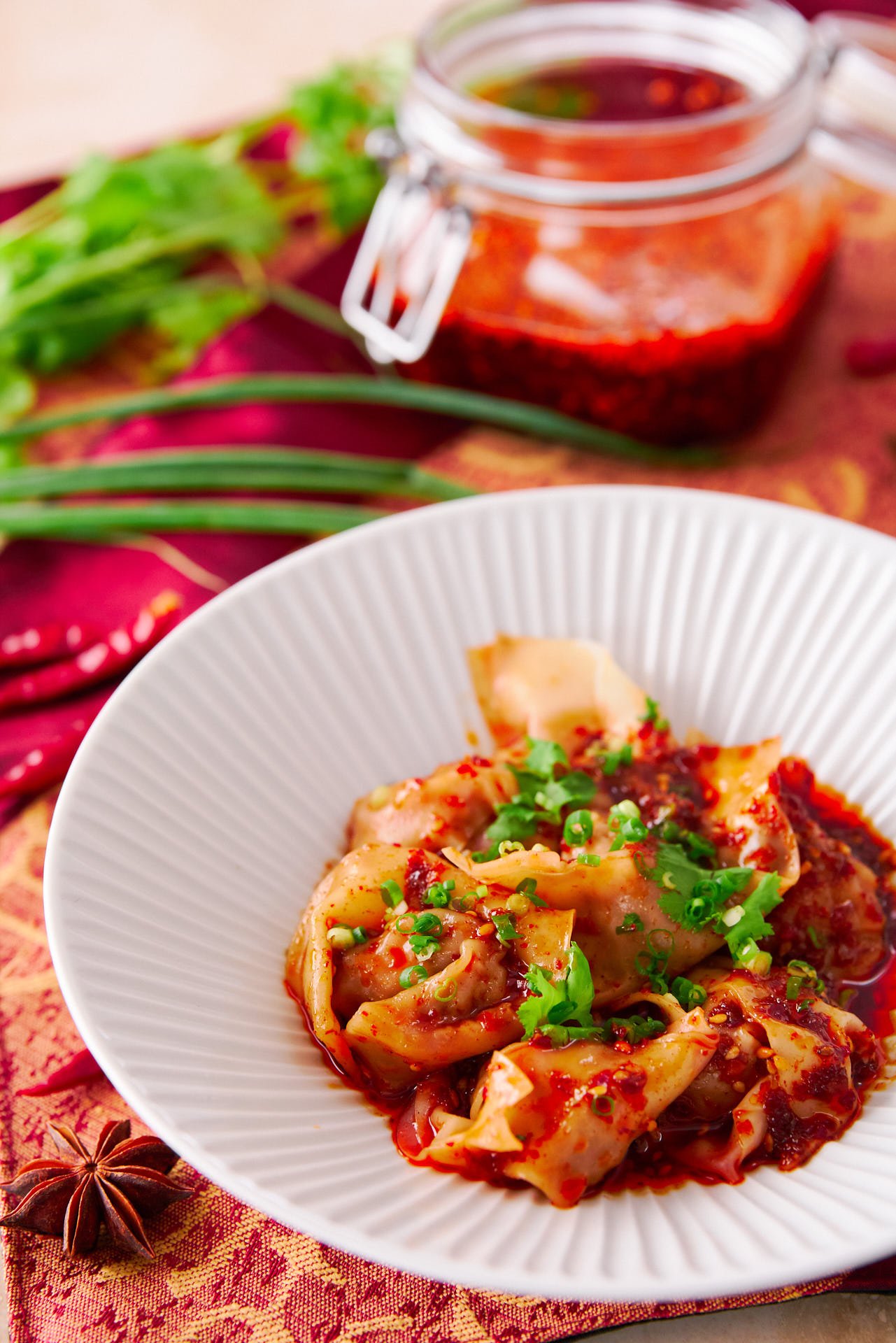 With tender pork dumplings wrapped in a slick noodle and tossed with a fiery Sichuan-style sauce, these Spicy Wontons in Chili Oil are easy to make and delicious!.