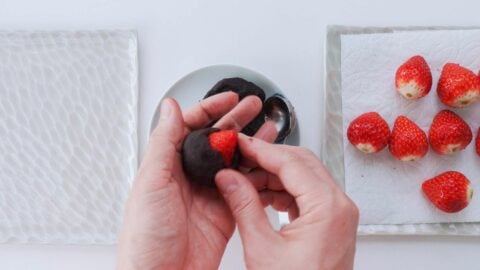 Wrap the base of the strawberry with anko, leaving the tip exposed.