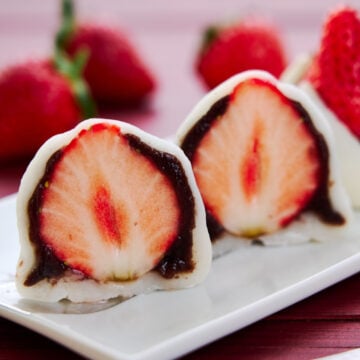 Cross-section of Strawberry Mochi showing a juicy strawberry wrapped in sweet red bean paste and sticky mochi.