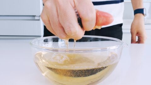 Squeezing shiitake mushroom stock from rehydrated mushrooms.