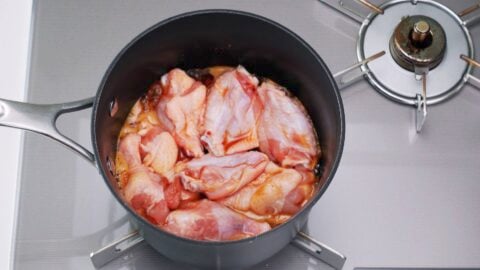 Chicken wings braising in teriyaki sauce.