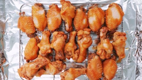 Teriyaki chicken wings on a wire rack to bake.