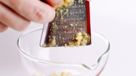 Grating ginger for teriyaki sauce.