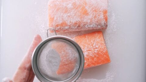 Dusting salmon with potato starch ensures the teriyaki sauce sticks to it.