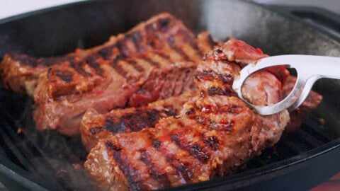 Hanger steaks with grill marks on grill pan.