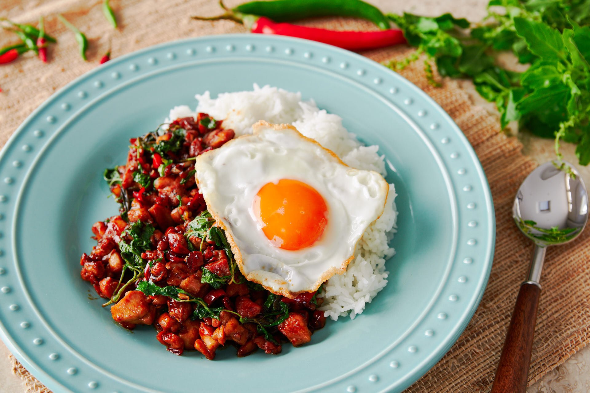 Basil Chicken or Pad Kraprow Gai is a classic Thai street food that can be thrown together at home in a matter of minutes. With spicy, garlic infused chicken and basil on Jasmine rice, the dish is topped off with a Thai-style fried egg.