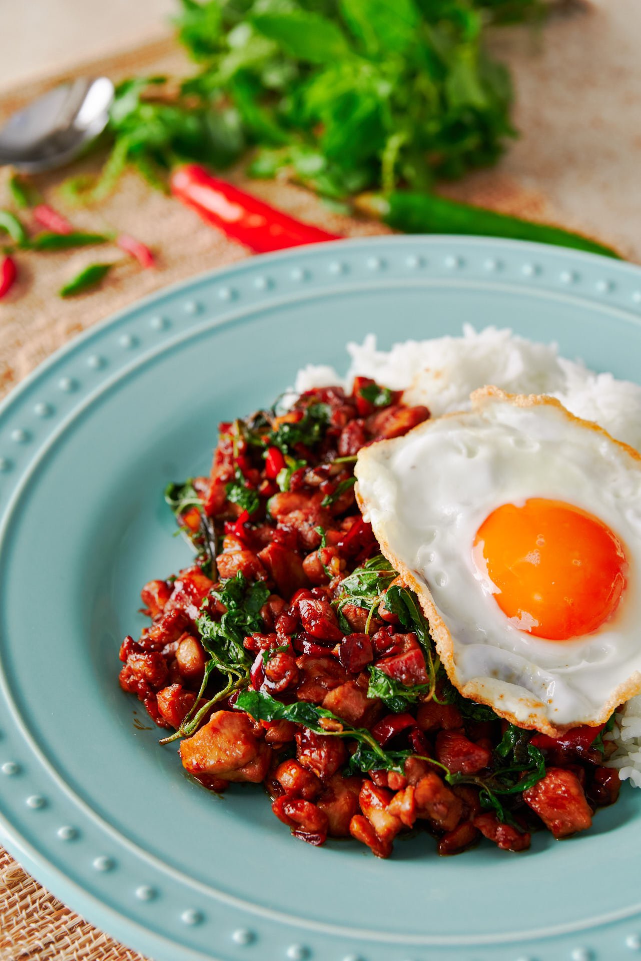 Spicy, with a mouthwatering balance of savory and sweet, this Thai Basil Chicken is a quick stir-fry that will fill your kitchen with the hunger-inducing aromas of garlic and holy basil.