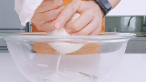 Squeeze out the excess water from the tofu.