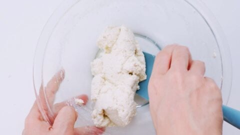 Kneading the tofu together with seasonings.