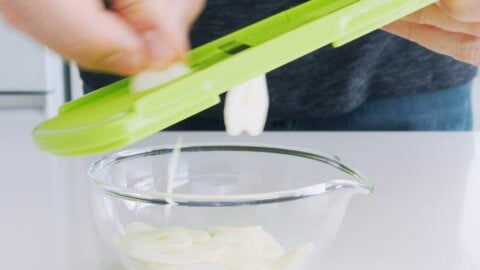 Slicing garlic for garlic chips.