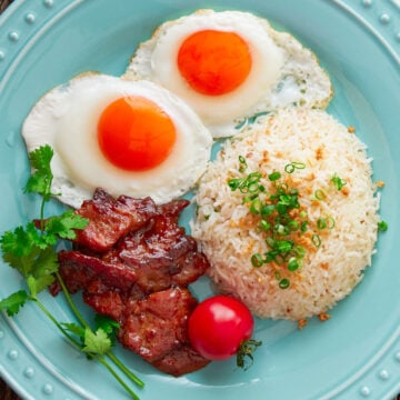 The Best Tosilog Recipe, with home-cured Tocino (Filipino Bacon), Sinangag (garlic fried rice), and sunny side up eggs.