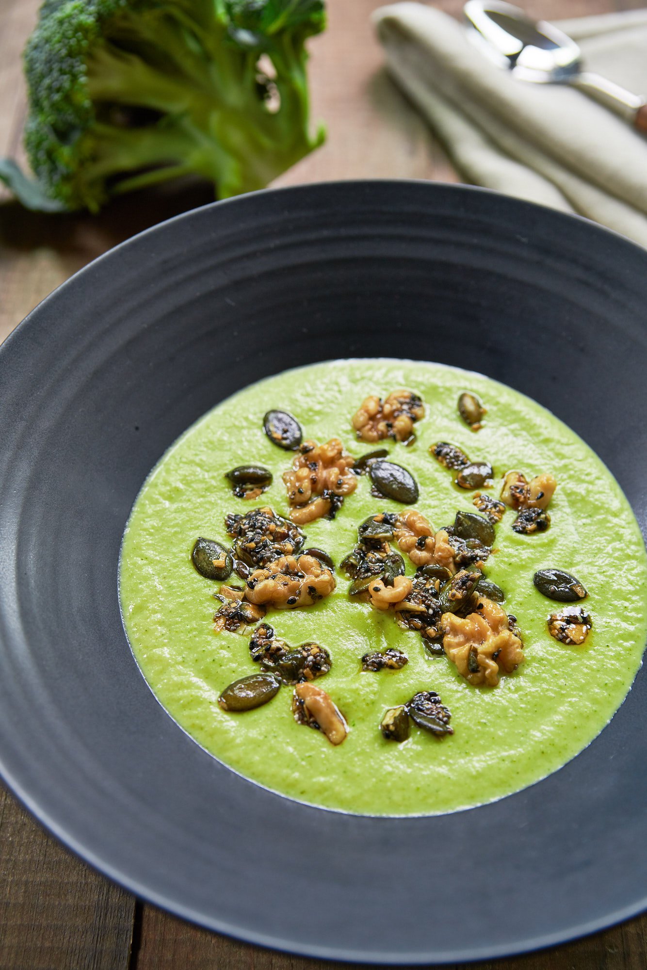 This plant-based Broccoli Cheese Soup is just as flavorful and creamy as the original, and it's topped with a fragrant medley of crunchy seeds and garlic oil.