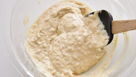 Stir in the remaining caramelized onions into the vegan French onion dip and adjust seasonings to taste.