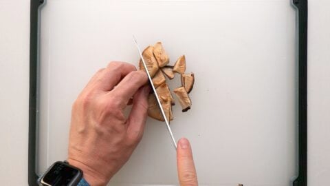 Chopping rehydrated shiitake mushrooms for Vegan Mapo Tofu.