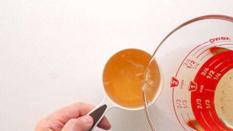 Measuring out shiitake mushroom stock.