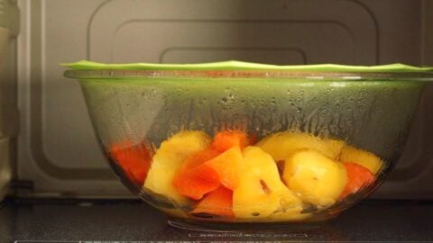 Potatoes and carrots microwaved in a glass bowl.