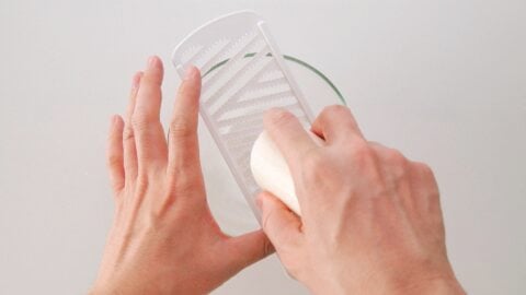 Grating yamaimo on a daikon grater for Okonomiyaki.