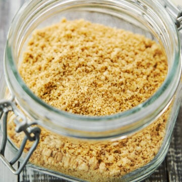 This easy 5 ingredient plant-based parmesan cheese sprinkles like parmesan, tastes like parmesan and makes any dish you add it to taste better.