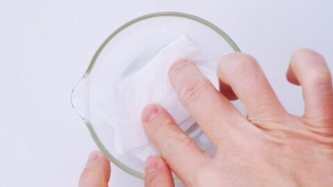 Preparing oil soaked paper towel to grease pan.