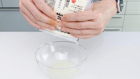 Squeeze out water from pack of tofu.