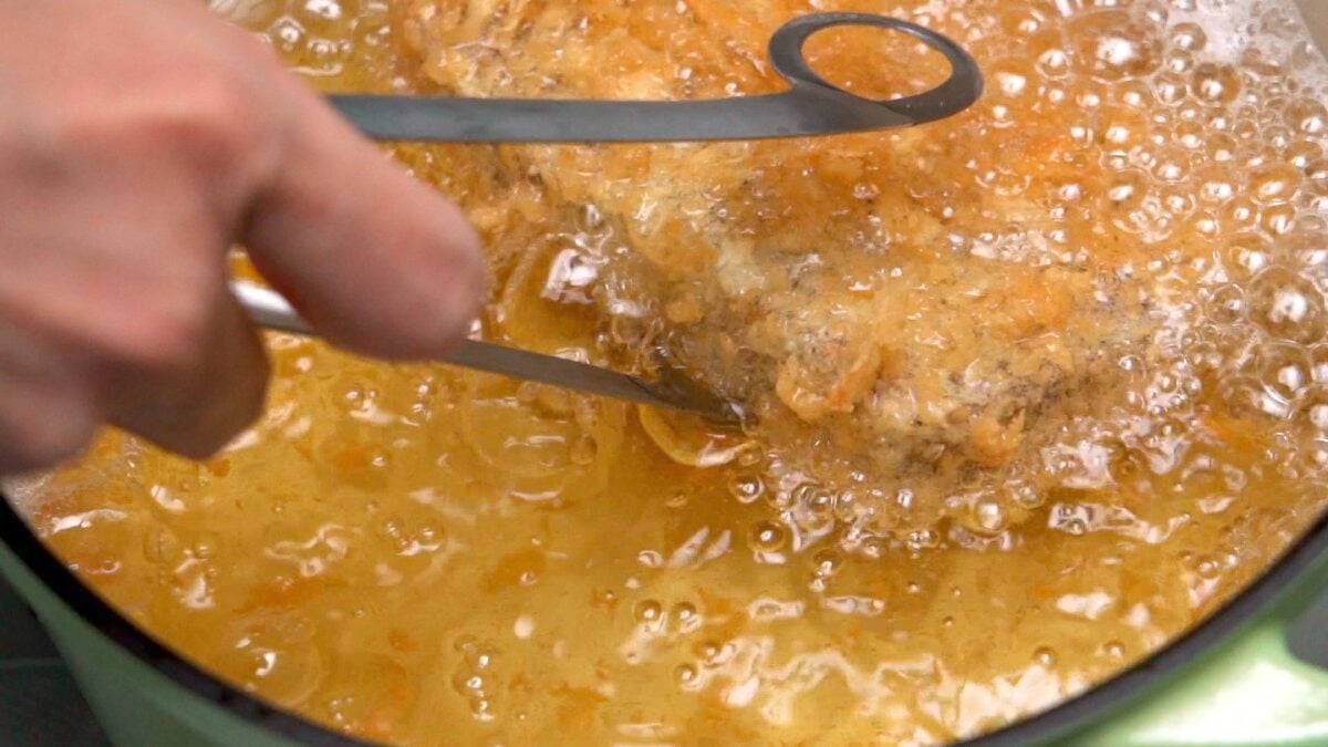 Deep frying Wagyu Katsu in a pot of oil.