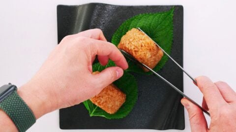 Plating Yaki Onigiri on top of Shiso leaves.